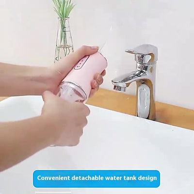 Four portable electric water flossers in green, pink, black, and silver, with clear water tanks, displayed next to their box. - Image 15