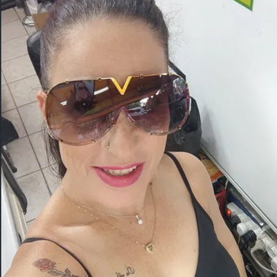 Oversized V-shaped sunglasses with a gold metal frame, white accents, clear lenses, and decorative rivets. - Image 3
