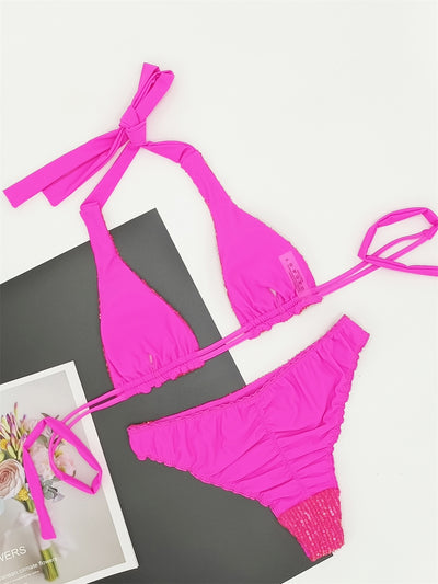 Pink and yellow sequined halter bikini top and high-cut bottoms on a model against a clear blue sky. - Image 25