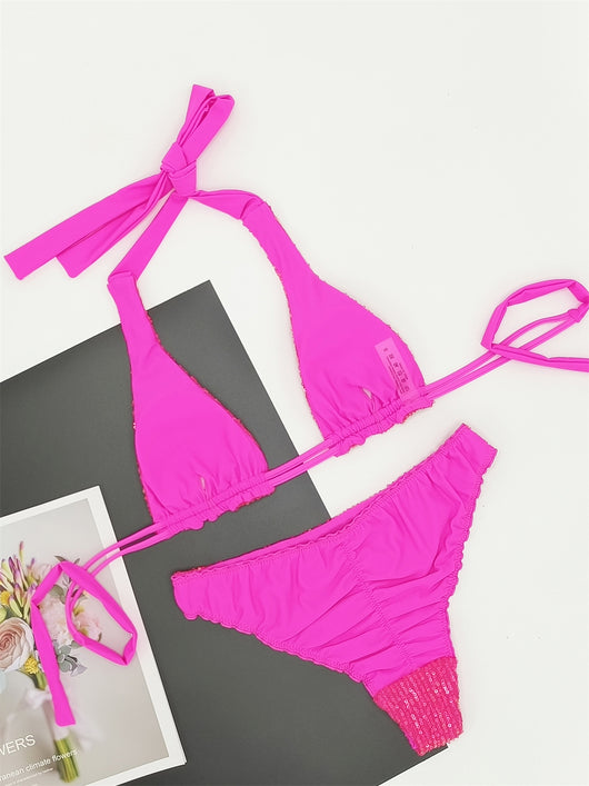 Pink and yellow sequined halter bikini top and high-cut bottoms on a model against a clear blue sky. - Image 25