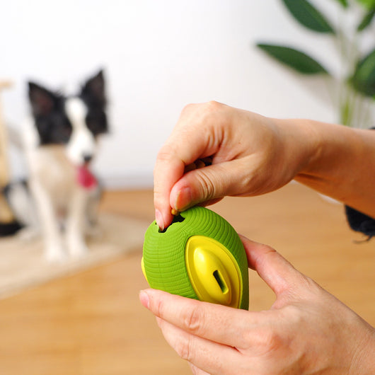 Green and yellow avocado-shaped rubber dog chew toy with a textured surface and a treat dispensing slot. - Image 3