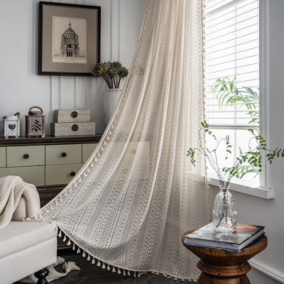 Translucent off-white American Country hollow crochet curtain with intricate patterns and tassel trim, draped by a window. - Image 6