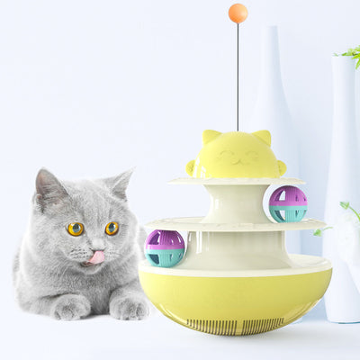 A playful kitten stands on its hind legs, batting at a dangling toy attached to a green and white multi-level cat track toy with rolling balls. - Image 7