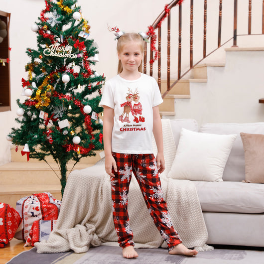 Family of five wearing matching Christmas pajamas with white 'Cousin Crew' tops and red plaid snowflake pants. - Image 10