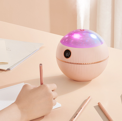 Pink spherical humidifier with a white top, ribbed texture, rose gold band, and a digital display showing 73%. - Image 13