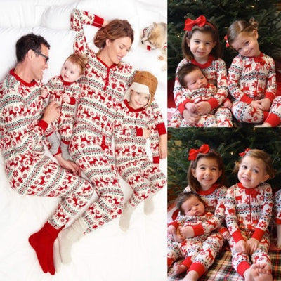 Family of four and a dog wearing matching long-sleeved Christmas pajamas with red reindeer and green snowflake print. - Image 9