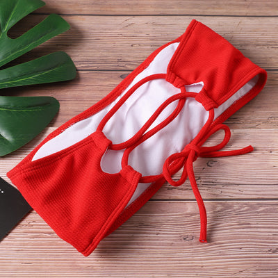 Pink ribbed bandeau bikini set with tie-back straps and high-cut bottoms on a light wooden surface. - Image 12