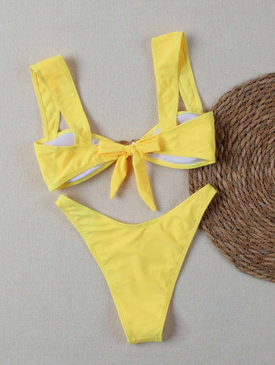 Bright yellow bikini with wide shoulder straps and a gold metal decoration on the top, worn by a woman. - Image 8