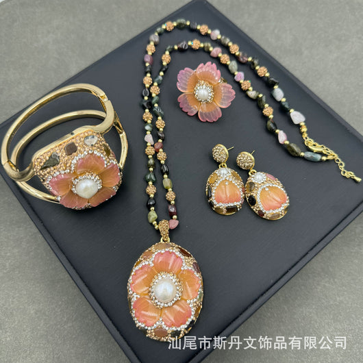 Gold-toned dangle earrings with oval drops, featuring a carved pink flower, clear rhinestones, and multi-colored tourmaline. - Image 12