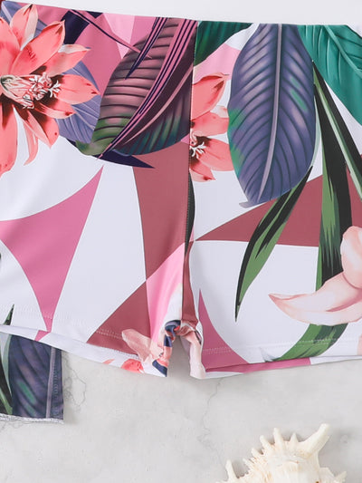 Woman in a three-piece bikini swimsuit set with a black tube top, floral boy shorts, and a sheer floral kimono cover-up. - Image 22