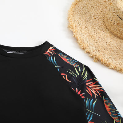 Women's long-sleeve tankini swimsuit with black top and blue tropical leaf print raglan sleeves, matching swim shorts. - Image 25