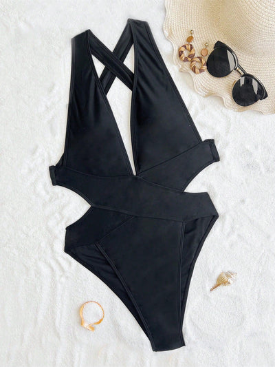 Woman in a black one-piece swimsuit with a deep V-neck and criss-cross waist cutouts, wearing a straw hat. - Image 11