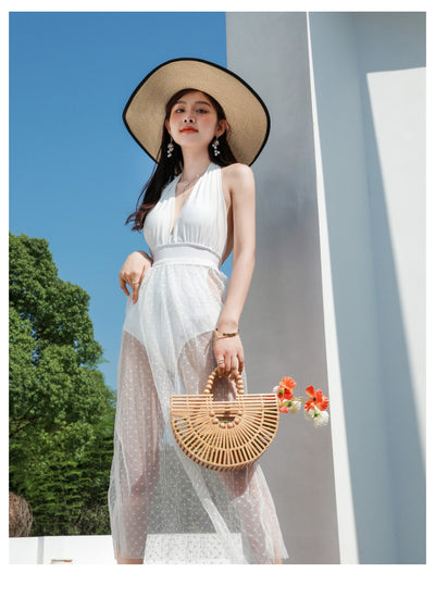 Woman in a white backless halter swimsuit with a sheer polka dot cover-up skirt, straw hat, and bamboo bag. - Image 22