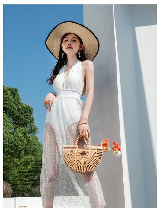 Woman in a white backless halter swimsuit with a sheer polka dot cover-up skirt, straw hat, and bamboo bag. - Image 22