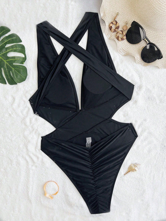 Woman in a black one-piece swimsuit with a deep V-neck and criss-cross waist cutouts, wearing a straw hat. - Image 9