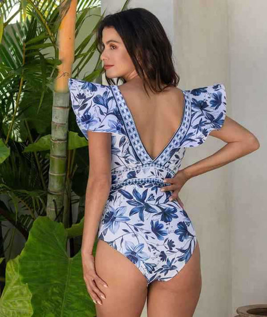 Women's blue and white floral one-piece swimsuit with ruffled V-neck and matching sarong skirt with bow. - Image 20