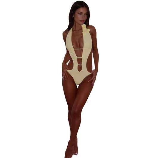 White halter monokini with deep V-neck, side cut-outs, and pearl bead embellishments on a woman at the beach. - Image 12