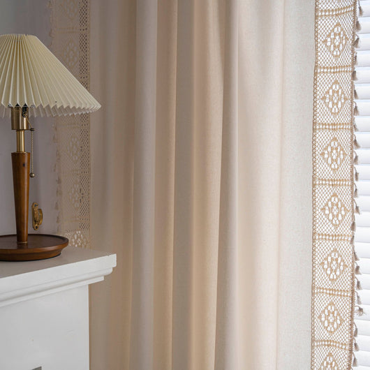 Close-up of a beige semi-transparent curtain with a delicate crochet lace trim and decorative tassels. - Image 30