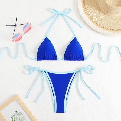 Royal blue two-piece bikini with light blue trim and tie straps, laid flat on a white textured surface. - Image 28
