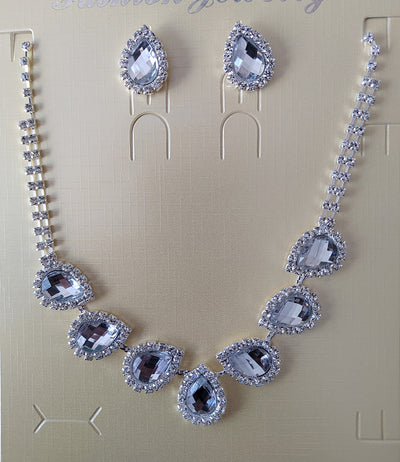 Purple teardrop rhinestone necklace and matching stud earrings set on a black background. - Image 28