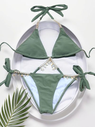 Olive green split bikini with gold chain and charm embellishments, worn with a sheer white cover-up on a beach. - Image 14