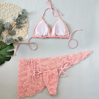 Red three-piece bikini set with a halter top, tie-side thong bottom, and sarong, all featuring a raised floral pattern. - Image 32