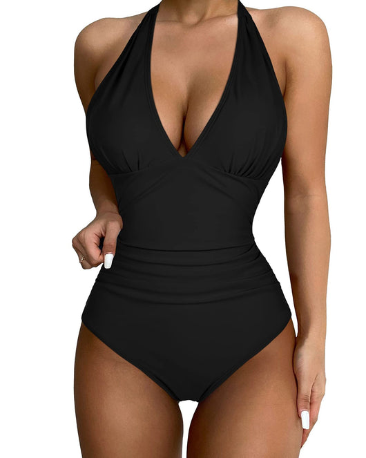 Black halter one-piece swimsuit with a deep V-neck and ruched detailing, designed for a slimming vacation look. - Image 13