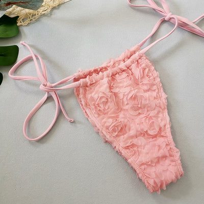 Red three-piece bikini set with a halter top, tie-side thong bottom, and sarong, all featuring a raised floral pattern. - Image 26