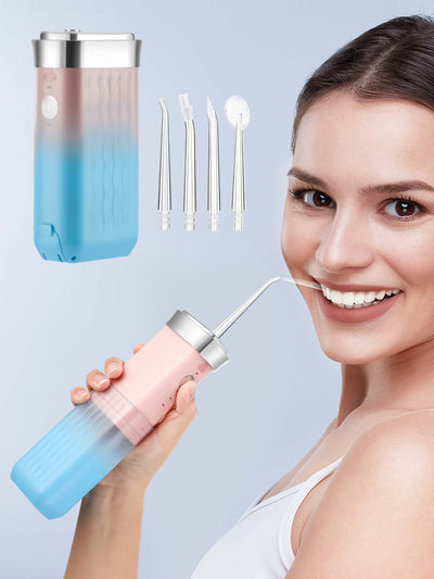 Portable water flosser in gradient pink and blue with four nozzles, a charging cable, and its product box. - Image 30