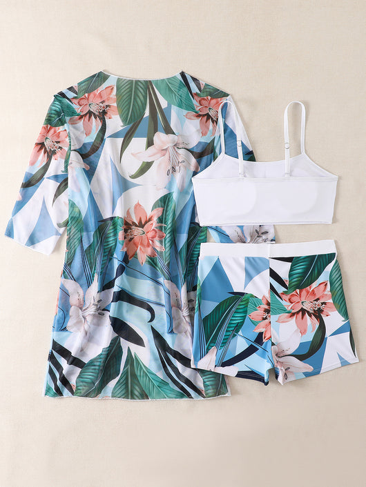 Woman in a three-piece bikini swimsuit set with a black tube top, floral boy shorts, and a sheer floral kimono cover-up. - Image 46