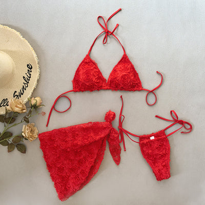 Red three-piece bikini set with a halter top, tie-side thong bottom, and sarong, all featuring a raised floral pattern. - Image 44