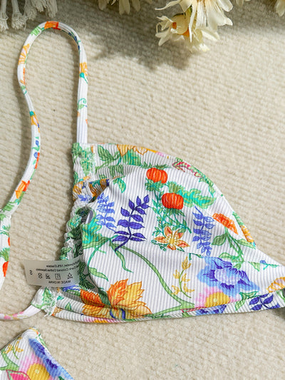 White ribbed two-piece bikini with colorful floral print, featuring a bandeau top and high-cut bottom. - Image 20