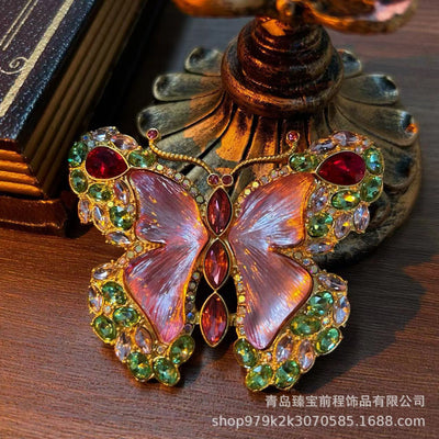 Pink enamel butterfly brooch with green, red, and clear rhinestones set in gold-toned metal. - Image 11