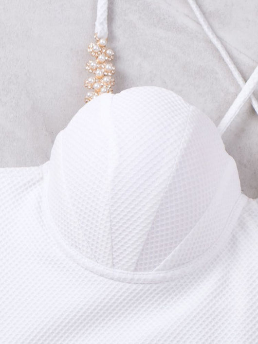 White textured two-piece bikini with a scalloped top and high-waisted bottom, worn by a woman on a sandy beach. - Image 11