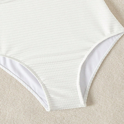White textured one-piece swimsuit with deep V-neck and wooden O-ring detail, styled with a light-wash denim jacket. - Image 9