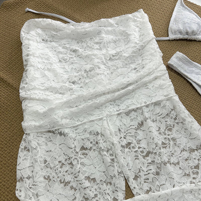 Woman wearing a white lace two-piece swimsuit set with a halter bikini top and sheer high-waisted flare pants. - Image 14