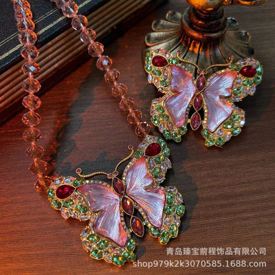 Pink enamel butterfly brooch with green, red, and clear rhinestones set in gold-toned metal. - Image 15