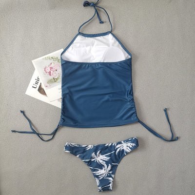 Women's blue halter tankini top with white palm tree graphic and "live simple" text, paired with matching high-waist bikini bottoms with palm print and side tie - Image 21