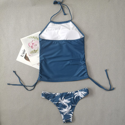 Women's blue halter tankini top with white palm tree graphic and "live simple" text, paired with matching high-waist bikini bottoms with palm print and side tie - Image 21