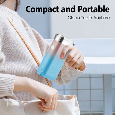 Portable water flosser in gradient pink and blue with four nozzles, a charging cable, and its product box. - Image 12