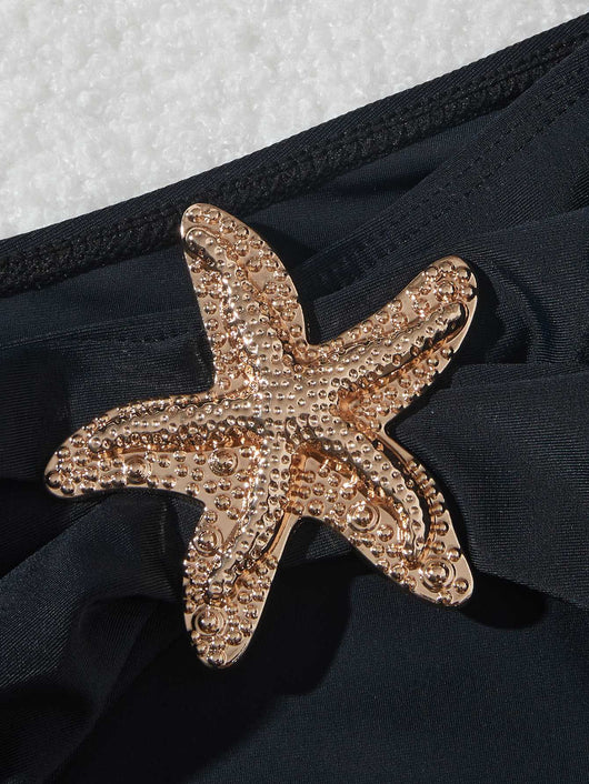 Black three-piece bikini set with triangle top, thong bottom, and skirt, all featuring gold starfish embellishments. - Image 17