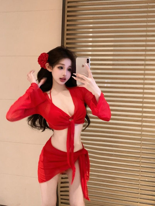 Red four-piece bikini set with sheer long-sleeve tie-front top and matching tie-front skirt on a beach. - Image 10