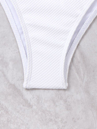 White textured two-piece bikini with a scalloped top and high-waisted bottom, worn by a woman on a sandy beach. - Image 21