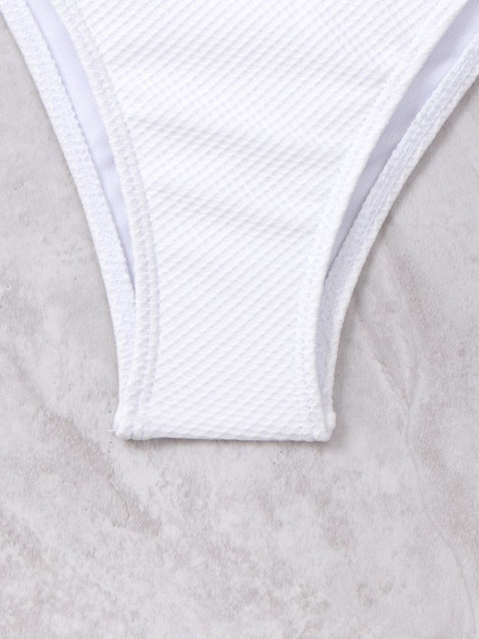 White textured two-piece bikini with a scalloped top and high-waisted bottom, worn by a woman on a sandy beach. - Image 21