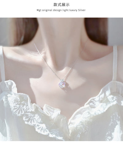 Gold-tone necklace with an iridescent camellia flower pendant and small clear stones on a delicate chain. - Image 13