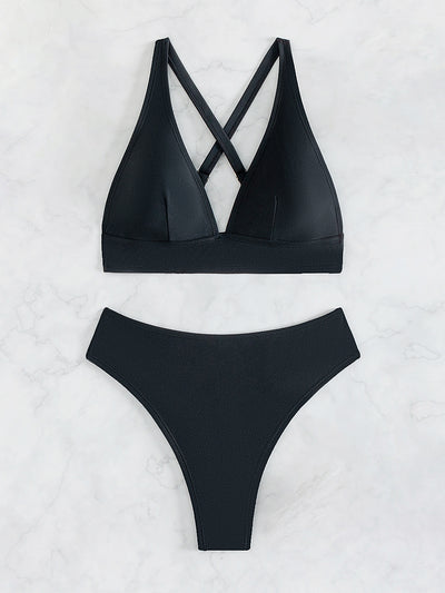 Bright blue two-piece bikini with a V-neck halter top and high-cut bottoms on a woman at the beach. - Image 12
