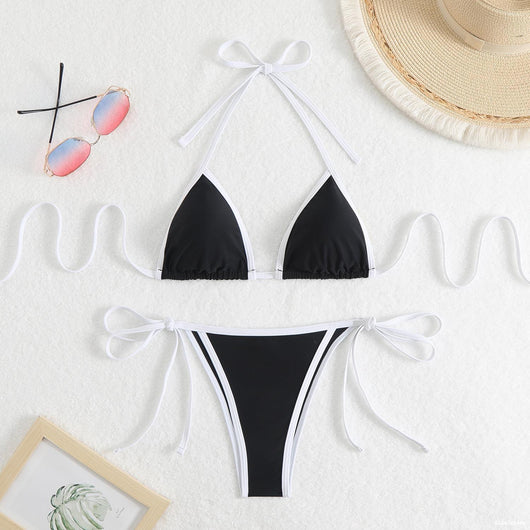 Royal blue two-piece bikini with light blue trim and tie straps, laid flat on a white textured surface. - Image 20