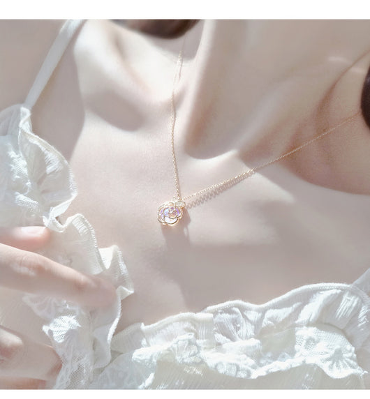 Gold-tone necklace with an iridescent camellia flower pendant and small clear stones on a delicate chain. - Image 17