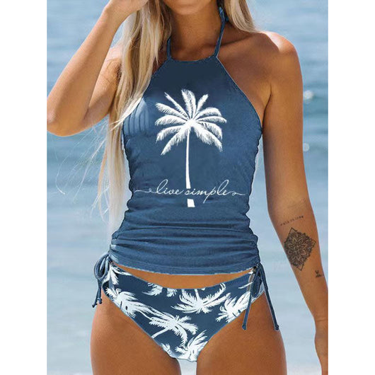 Women's blue halter tankini top with white palm tree graphic and "live simple" text, paired with matching high-waist bikini bottoms with palm print and side tie - Image 17
