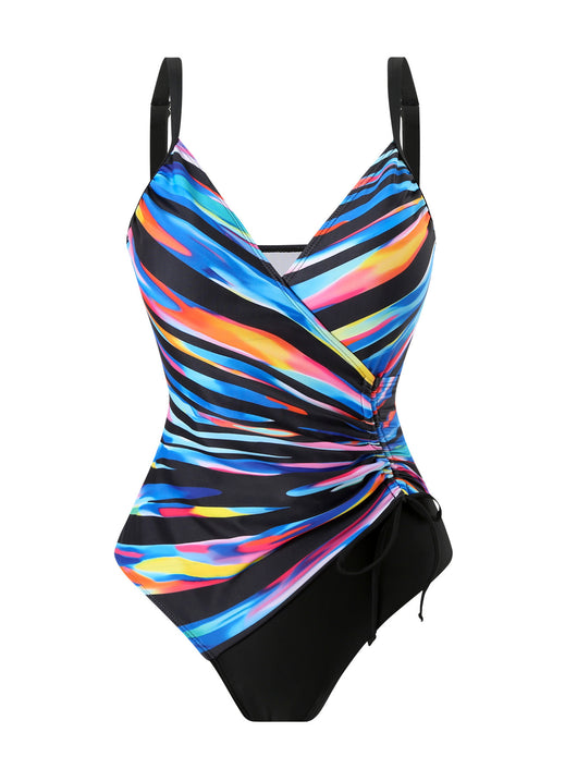 Woman in a navy and white striped tankini swimsuit with a wrap-front and side drawstring, holding a woven bag. - Image 28